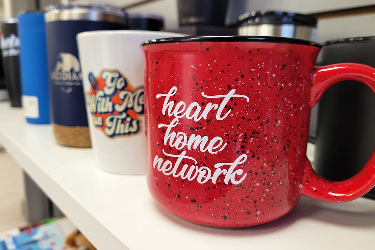 Branded mugs and tumblers printed with client logos